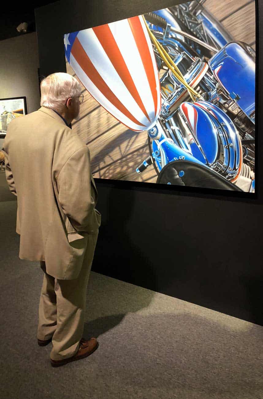 An art patron looks over AMERICA painting at MOAS 2018